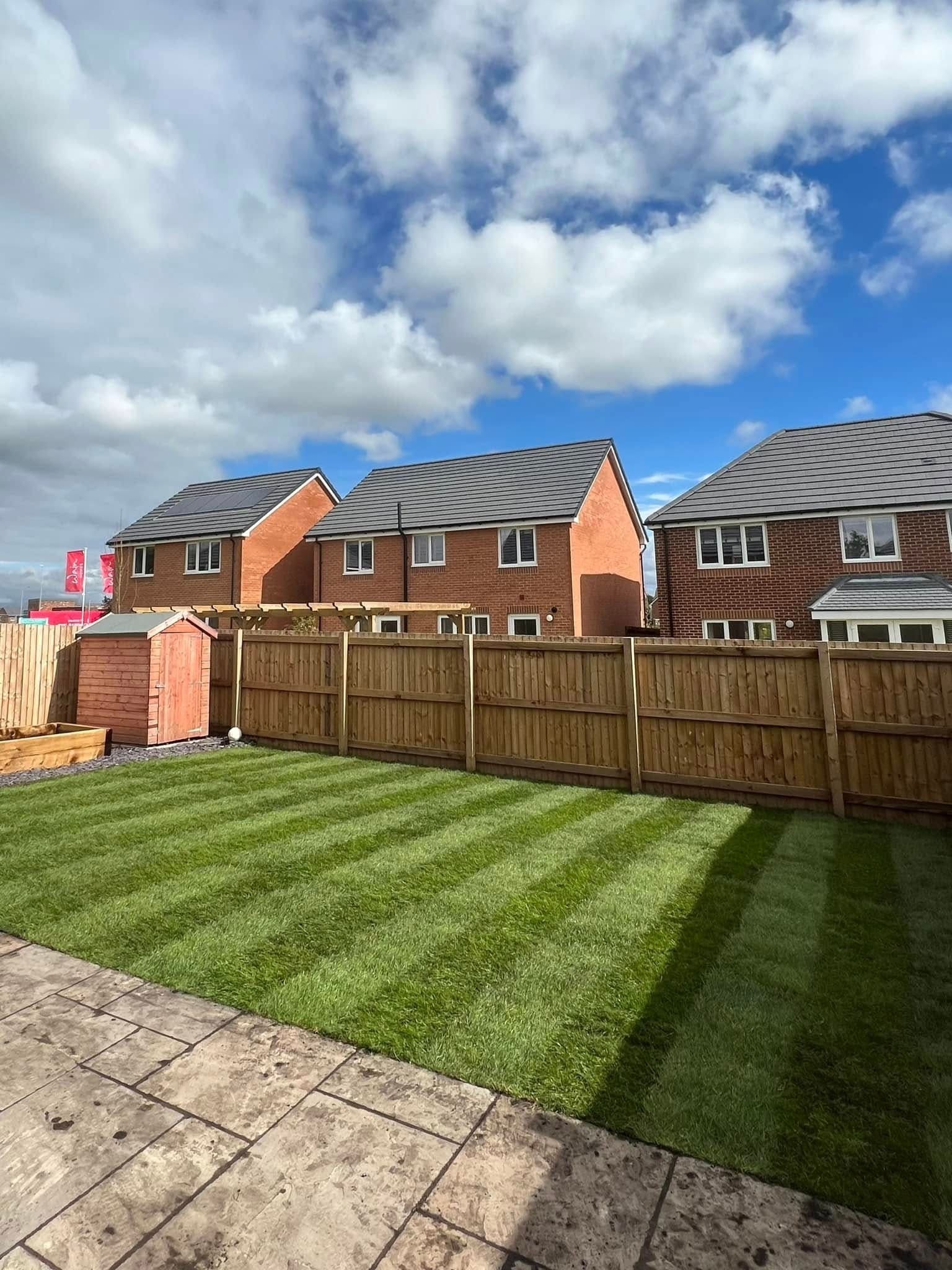After: freshly turfed new build garden with patio and fencing