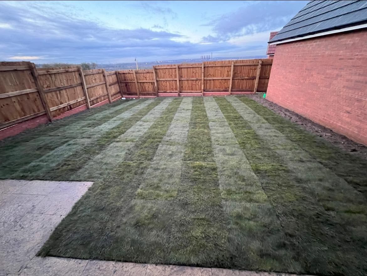 After: freshly turfed rear garden with fence panels